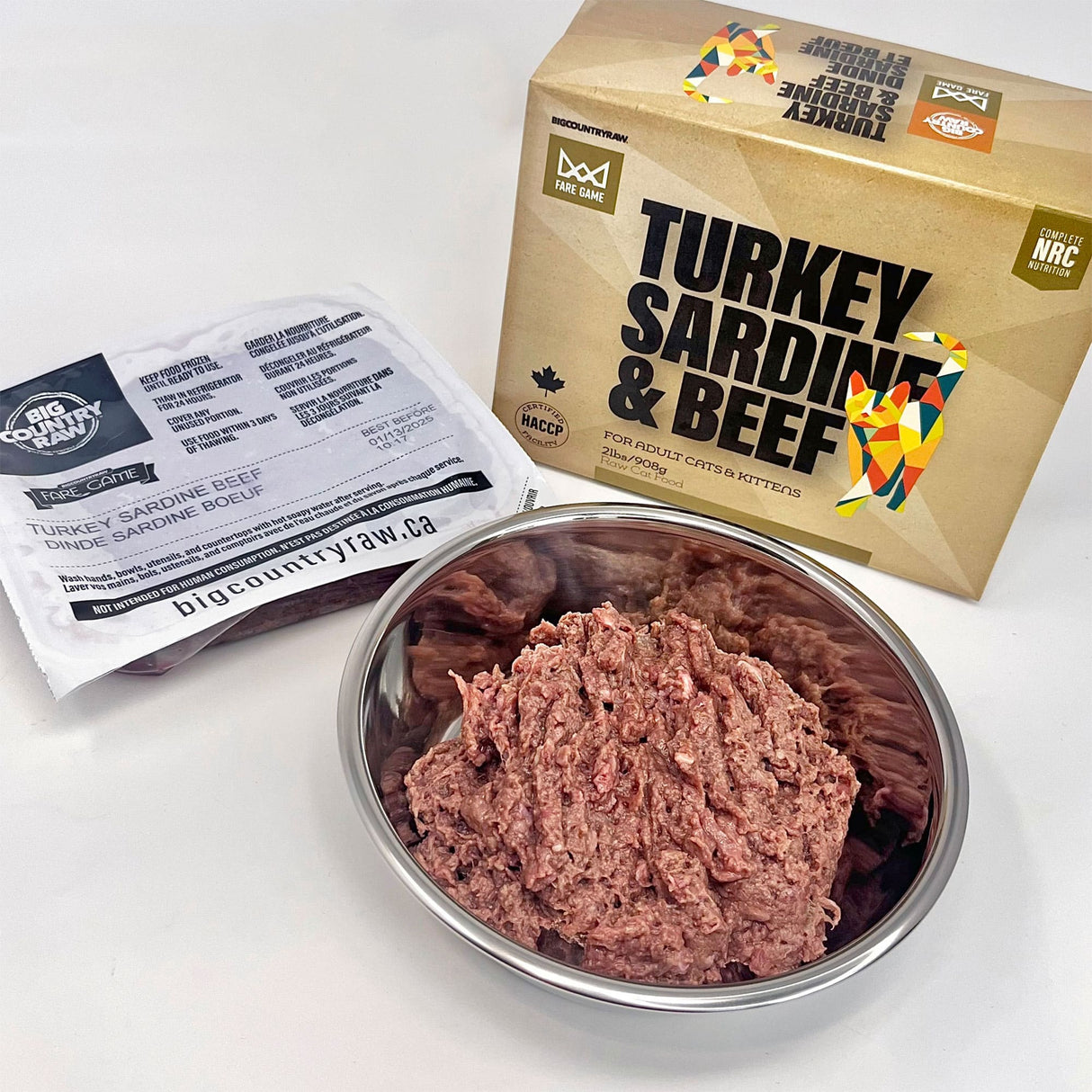 Fare Game Turkey and Sardines with Beef by Big Country Raw: Packaged raw cat food with visible thawed blend in a stainless-steel bowl.