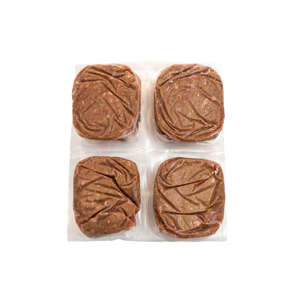 Red Dog Blue Kat Lamb for Cats: Four vacuum-sealed raw lamb patties, arranged in a 2x2 grid, offering single-protein, freezer-friendly nutrition for cats.