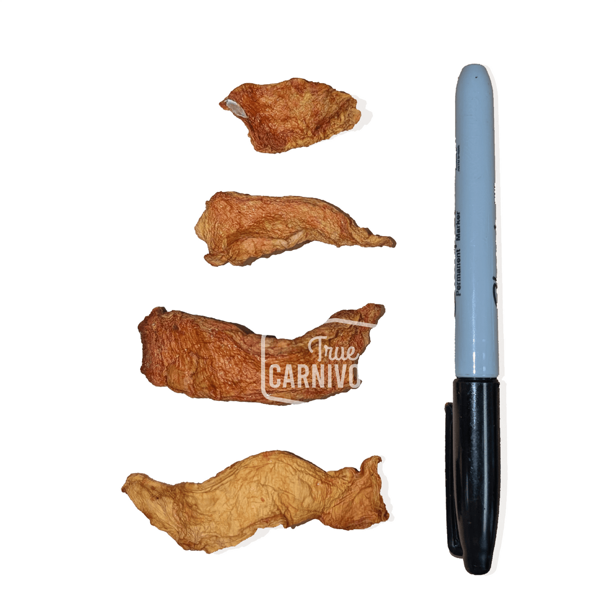 One Ingredient Air-Dried Pumpkin: Four thin, dehydrated pumpkin strips, soft and chewy, beside a marker for scale, ideal low-calorie, high-fiber dog treats.