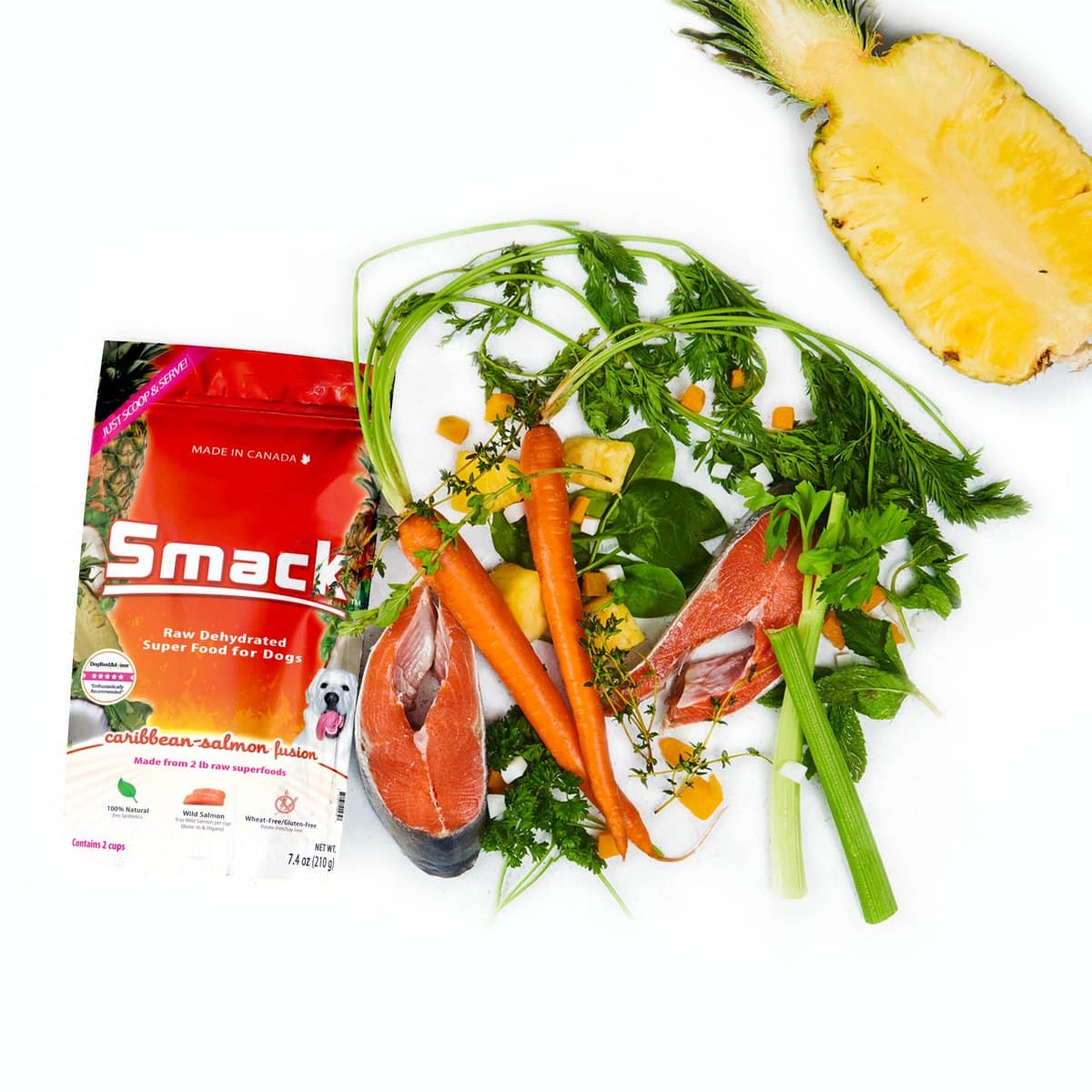 Smack Caribbean-Salmon Fusion for Dogs, featuring salmon steaks, carrots, celery, herbs, and pineapple, arranged to highlight its raw, dehydrated superfood ingredients.