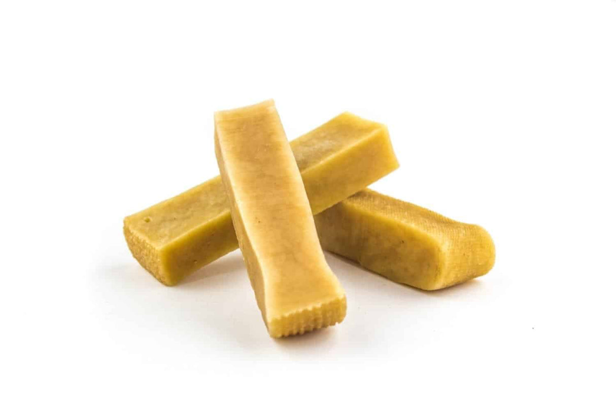 Medium Himalayan Yak Chews - 4 Pack: Three tan, rectangular chews, 4-5 inches long, made from yak and cow milk, offering a natural, long-lasting treat for dogs.