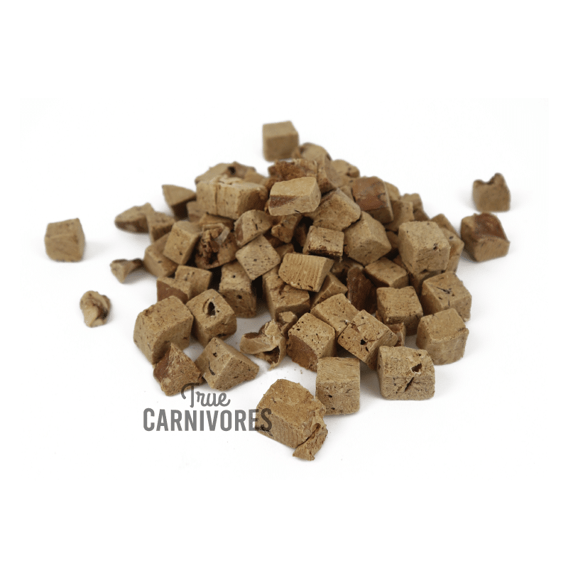 Pile of small, cube-shaped One Ingredient Freeze-Dried Pork Liver Bites, showcasing the True Carnivores logo, ideal for pet training or as meal toppers.