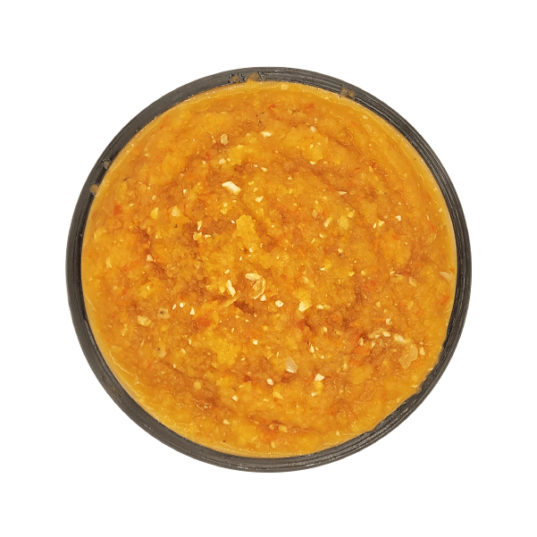 Top-down view of Back 2 Basics Digestive Blend, a round black container filled with bright orange pumpkin purée, rich in nutrients and fiber.