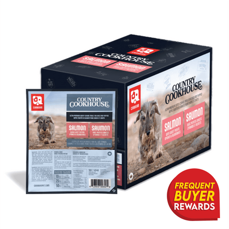 Caravan Country Cookhouse Salmon dog meal packaging with Frequent Buyer Rewards badge, featuring a running dog image, highlighting real salmon, Omega-3 benefits, and Canadian-made quality.