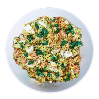 Tom & Sawyer Coconut Chicken: A vibrant rice salad with yellow grains, carrots, pale vegetables, and fresh herbs, showcasing gently cooked chicken and coconut in a nutritious blend.