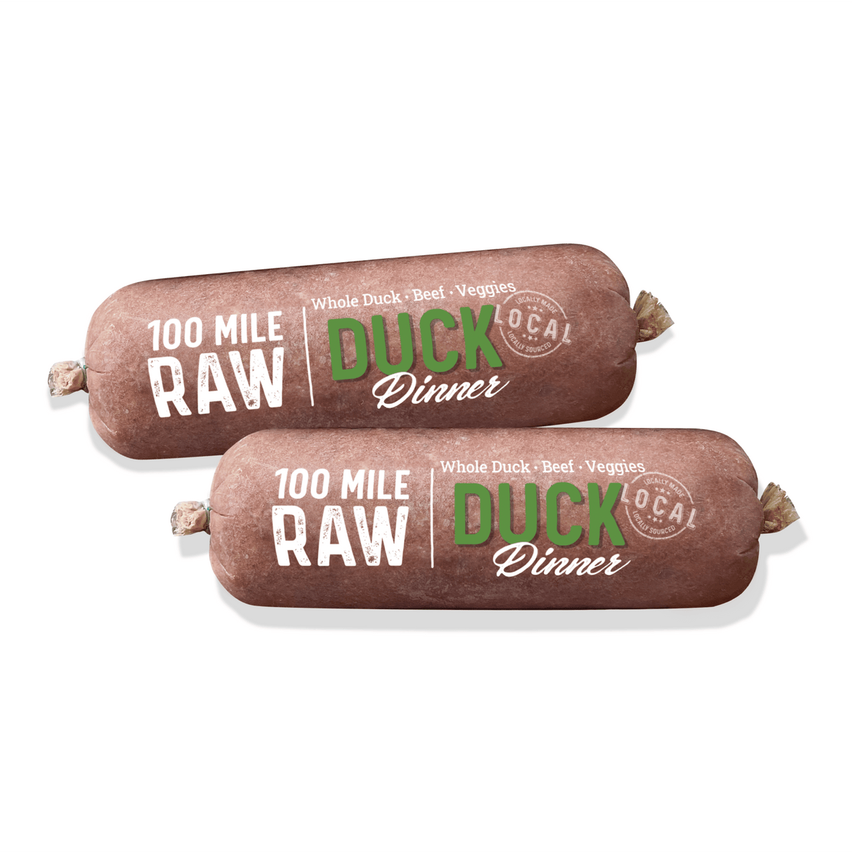100 Mile Raw Duck Dinner: Two cylindrical raw food rolls labeled for dogs, featuring whole duck, beef organs, and veggies, locally sourced within 100 miles of Vancouver.