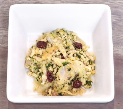 Tom & Sawyer Fisherman's Best Friend, a bowl of riced cauliflower salad with onions, herbs, dried berries, and nuts, designed as a nutritious, fish-forward dog meal.