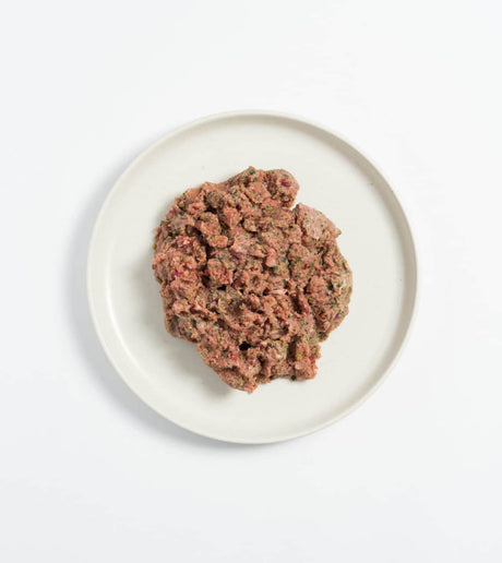 Rawbone Mixed Protein Rabbit Meal on a white plate, showcasing raw, minced meat with integrated organs and bone, ideal for raw feeding and portioning.