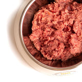 Big Country Raw Pure Pork in a metal pet bowl, showcasing moist, ground-meat texture, highlighting its single-protein, hypoallergenic benefits for energy and food sensitivity support.