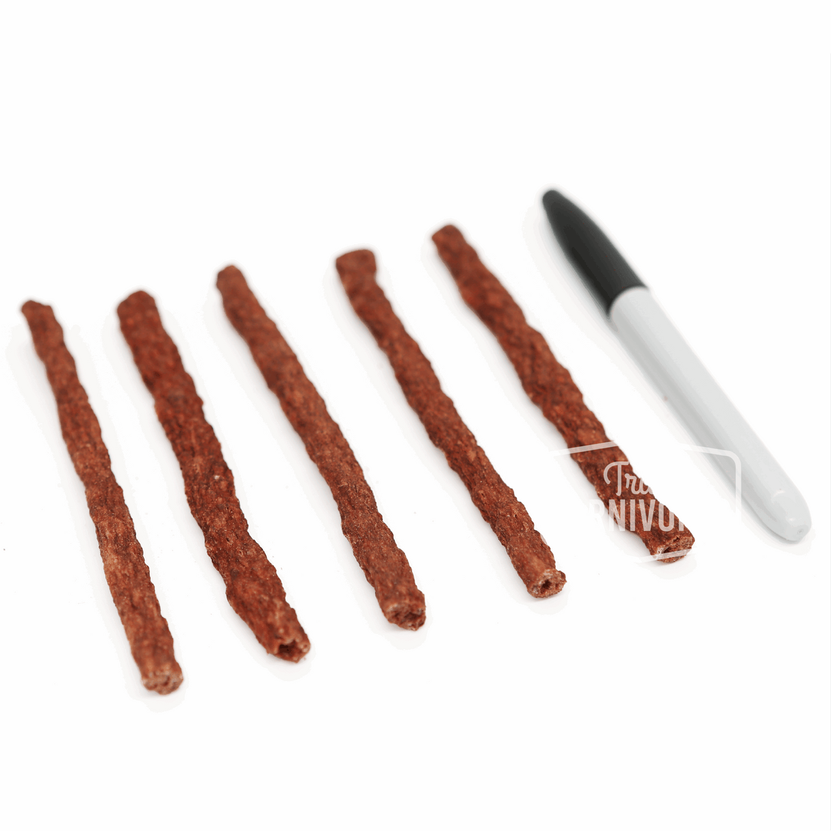 Five One Ingredient Beef Sticks, crunchy pet treats made from Argentine beef esophagus, arranged beside a marker for scale, highlighting their 6-inch length.