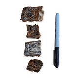 One Ingredient Cod Skin Bites 400g: Four small, dried fish skin treats next to a Sharpie for scale, showcasing crunchy, single-ingredient pet snacks from True Carnivore.
