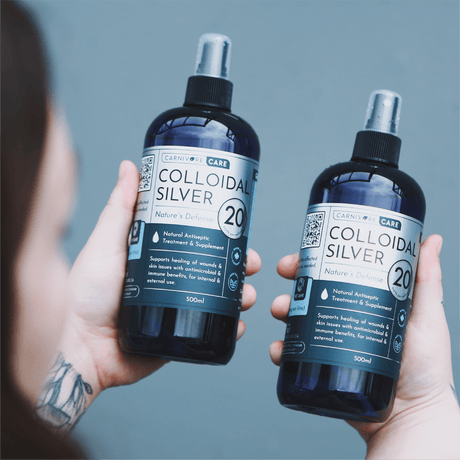 Carnivore Care Colloidal Silver Spray 20PPM 500mL Bottle held in hands, labeled for natural antiseptic and antimicrobial use for pets' skin and wound healing.