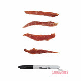 Four strips of dried duck breast fillet above a Sharpie marker for scale, featuring the True Carnivores logo.