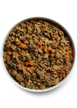 Open Farm Gently Cooked Puppy Recipe in a white bowl with diced carrots and green bits, showcasing a moist, nutritious blend for growing pups.