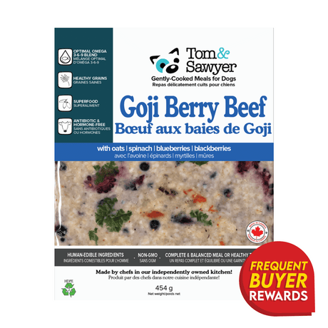 Tom & Sawyer Goji Berry Beef dog meal label highlights beef with goji berries, fruits, veggies, antibiotic-free meat, non-GMO ingredients, and a Frequent Buyer Rewards badge.