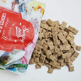Sunday Pets Lamb for Dogs pouch with spilled square kibble bites, highlighting its dehydrated lamb formula for versatile feeding as a meal or topper.