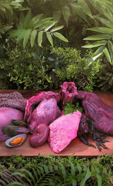 Ziwi Peak Venison for Cats displayed with raw offal and seafood, emphasizing its air-dried, high-meat content and jerky-like texture for convenient feline nutrition.