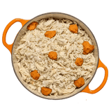 Tom & Sawyer Tummy Tamer in orange-handled dish with shredded chicken and orange purée, designed for sensitive dogs' digestion and hydration support.