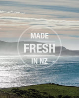 K9 Natural Canned Food for Dogs: Coastal landscape with grazing sheep and ocean. Made Fresh in NZ stamp. Protein-rich, moisture-rich meals, ready-to-serve.