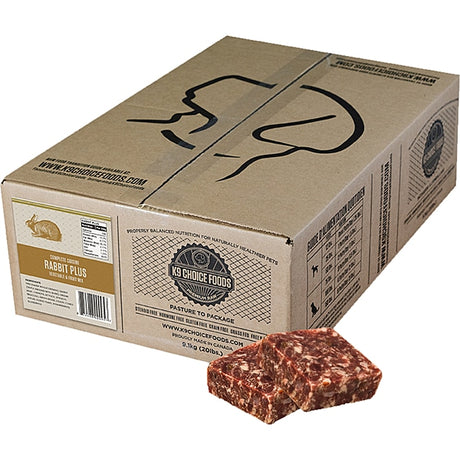 K9 Choice Rabbit Plus: Cardboard box with frozen raw dog food, featuring reddish-brown rabbit patties with fruit and veggie mix for balanced nutrition.
