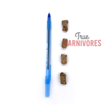 Carnivores Kitchen Crunchy Training Treats shown next to a blue pen for size, highlighting their small, irregular shape ideal for pocket storage during training.