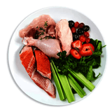 Smack Very Berry Chicken for Cats: A plate of raw poultry, salmon, berries, and greens, showcasing ingredients of this dehydrated raw cat food.