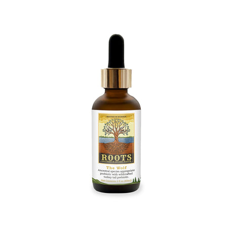 The Wolf Species Appropriate Liquid Probiotic by Adored Beast in a 60ml amber dropper bottle with tree-design label, featuring lupine probiotics and turkey-tail mushroom prebiotic.